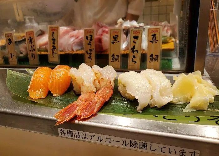 A serving of sushi at Uogashi Standing Sushi Bar, including salmon, prawn, and more Edomae sushi,